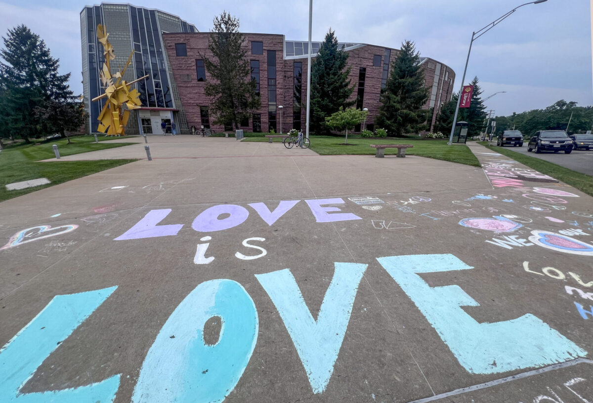After a "rainbow story time" caught state officials' attention, Columbia residents wrote affirming messages on the sidewalk in front of the Daniel Boone Regional Library branch near downtown Columbia (Annelise Hanshaw/Missouri Independent).